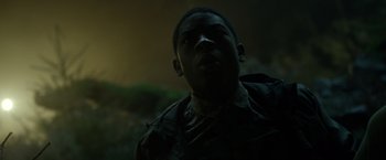 Movie still from “Power Rangers” (2017), directed by Dean Israelite – A young man is standing in the dark looking up; Close Up shot, Low angle
