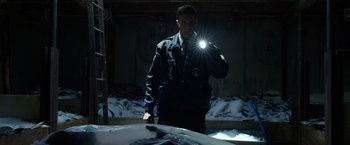 Movie still from “Power Rangers” (2017), directed by Dean Israelite – A man holding a flashlight in front of a car in the dark; Medium shot, Low angle