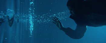 Movie still from “Power Rangers” (2017), directed by Dean Israelite – A man is swimming in a pool of bubbles; Medium shot, Low angle