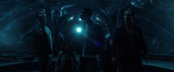 Movie still from “Power Rangers” (2017), directed by Dean Israelite – A group of people standing in a dark room; Medium shot, Low angle