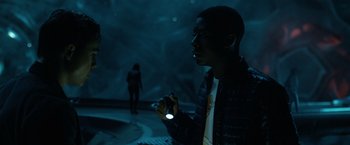 Movie still from “Power Rangers” (2017), directed by Dean Israelite – A man holding a flashlight while standing next to a woman; Medium shot, Over the shoulder angle