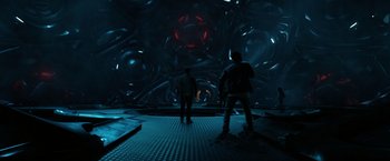 Movie still from “Power Rangers” (2017), directed by Dean Israelite – Two people are standing in a dark room; Wide shot, Low angle