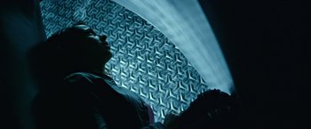 Movie still from “Power Rangers” (2017), directed by Dean Israelite – A man is looking up at the ceiling of a building; Medium shot, Overhead angle