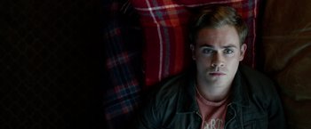 Movie still from “Power Rangers” (2017), directed by Dean Israelite – A man laying on the ground in a room; Close Up shot, Overhead angle