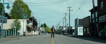 Movie still from “Power Rangers” (2017), directed by Dean Israelite – A man standing in the middle of the street; Wide shot, Low angle