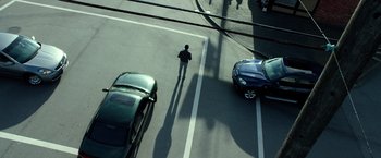 Movie still from “Power Rangers” (2017), directed by Dean Israelite – A man is standing in the middle of the street; Extreme Wide shot, Overhead angle