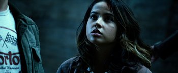 Movie still from “Power Rangers” (2017), directed by Dean Israelite – A young woman with long dark hair looking up at the sky; Close Up shot, Low angle