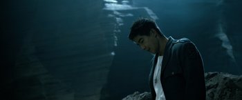Movie still from “Power Rangers” (2017), directed by Dean Israelite – A man standing in front of a body of water; Close Up shot, Low angle