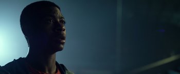 Movie still from “Power Rangers” (2017), directed by Dean Israelite – A young black man looking up at the sky; Close Up shot, Low angle