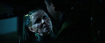 Movie still from “Power Rangers” (2017), directed by Dean Israelite – A woman with green makeup on her face and a man in a dark room; Close Up shot, Over the shoulder angle