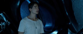Movie still from “Power Rangers” (2017), directed by Dean Israelite – A man in a white t - shirt is looking up; Close Up shot, Over the shoulder angle