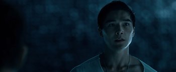 Movie still from “Power Rangers” (2017), directed by Dean Israelite – A young man is standing in the dark looking at the camera; Close Up shot, Low angle
