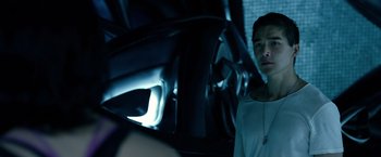 Movie still from “Power Rangers” (2017), directed by Dean Israelite – A person standing next to a steering wheel in a dark room; Close Up shot, Over the shoulder angle
