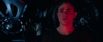 Movie still from “Power Rangers” (2017), directed by Dean Israelite – A young man in a black shirt is looking at the camera; Close Up shot, Low angle