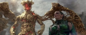 Movie still from “Power Rangers” (2017), directed by Dean Israelite – A woman standing next to a giant tree; Medium shot, Low angle
