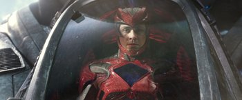 Movie still from “Power Rangers” (2017), directed by Dean Israelite – A man wearing a red and blue costume; Medium shot, Overhead angle