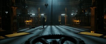 Movie still from “Predestination” (2014), directed by Michael Spierig – A person is standing in a dark room; Extreme Wide shot, Low angle