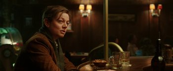 Movie still from “Predestination” (2014), directed by Michael Spierig – A woman sitting at a table with a bowl of food; Close Up shot, Over the shoulder angle