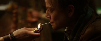 Movie still from “Predestination” (2014), directed by Michael Spierig – A person lighting a cigarette with a lighter; Close Up shot, Over the shoulder angle