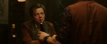 Movie still from “Predestination” (2014), directed by Michael Spierig – A woman smoking a cigarette while sitting in a chair; Close Up shot, Over the shoulder angle