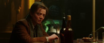 Movie still from “Predestination” (2014), directed by Michael Spierig – A man sitting at a table with a glass of wine; Close Up shot, Over the shoulder angle