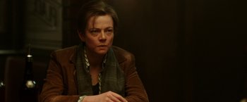 Movie still from “Predestination” (2014), directed by Michael Spierig – A woman in a brown jacket is looking at the camera; Close Up shot, Over the shoulder angle