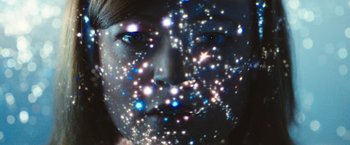 Movie still from “Predestination” (2014), directed by Michael Spierig – A woman's face is lit up by the lights; Extreme Close Up shot, Overhead angle