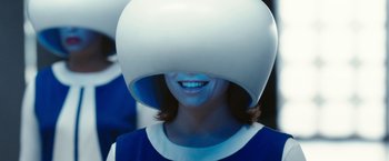 Movie still from “Predestination” (2014), directed by Michael Spierig – A woman wearing a helmet with a smile on her face; Close Up shot, Over the shoulder angle