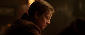 Movie still from “Predestination” (2014), directed by Michael Spierig – A woman with blonde hair sitting down with her eyes closed; Close Up shot, Over the shoulder angle