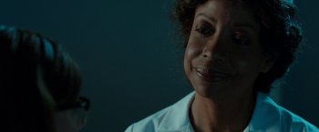 Movie still from “Predestination” (2014), directed by Michael Spierig – A person smiling; Close Up shot, Over the shoulder angle