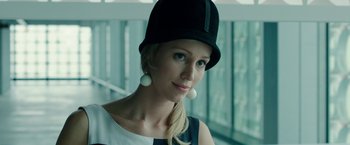 Movie still from “Predestination” (2014), directed by Michael Spierig – A woman wearing a black hat and white earrings; Close Up shot, Low angle