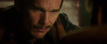 A man's face as he looks at the camera