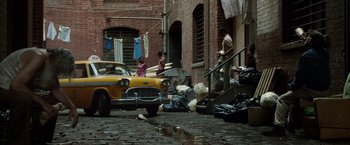 Movie still from “Predestination” (2014), directed by Michael Spierig – A yellow car parked on the side of the street; Wide shot, High angle