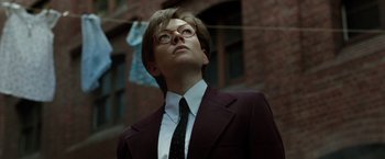 Movie still from “Predestination” (2014), directed by Michael Spierig – A man in a suit and tie looking up; Close Up shot, Low angle