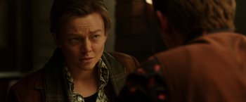 Movie still from “Predestination” (2014), directed by Michael Spierig – A person sitting in front of another person in front of a mirror; Close Up shot, Over the shoulder angle