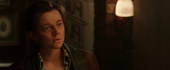 Movie still from “Predestination” (2014), directed by Michael Spierig – A man in a brown jacket is looking to his left; Close Up shot, Over the shoulder angle