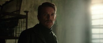 Movie still from “Predestination” (2014), directed by Michael Spierig – A person wearing a jacket; Close Up shot, Over the shoulder angle