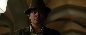 Movie still from “Predestination” (2014), directed by Michael Spierig – A man wearing a brown hat and a jacket; Close Up shot, Low angle