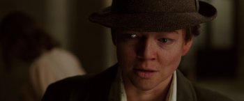Movie still from “Predestination” (2014), directed by Michael Spierig – A person wearing a hat; Close Up shot, Low angle