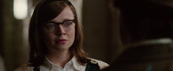 Movie still from “Predestination” (2014), directed by Michael Spierig – A woman wearing glasses looking at a man; Close Up shot, Over the shoulder angle