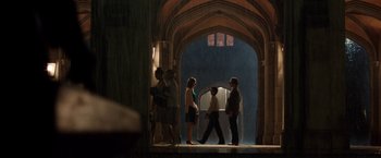 Movie still from “Predestination” (2014), directed by Michael Spierig – A group of people standing in front of an archway; Extreme Wide shot, High angle