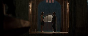 Movie still from “Predestination” (2014), directed by Michael Spierig – A man and a woman standing in front of an archway; Wide shot, Over the shoulder angle