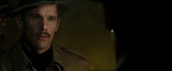 Movie still from “Predestination” (2014), directed by Michael Spierig – A person wearing a hat; Close Up shot, Over the shoulder angle