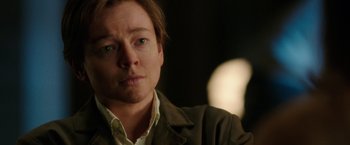 Movie still from “Predestination” (2014), directed by Michael Spierig – A person wearing a brown jacket; Close Up shot, Over the shoulder angle