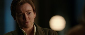 Movie still from “Predestination” (2014), directed by Michael Spierig – A person wearing a brown jacket; Close Up shot, Over the shoulder angle