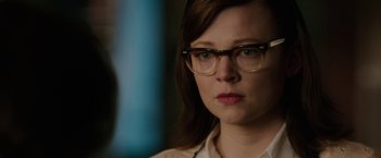 Movie still from “Predestination” (2014), directed by Michael Spierig – A person wearing glasses and looking at the camera; Close Up shot, Over the shoulder angle