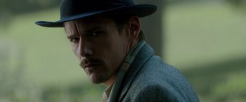 Movie still from “Predestination” (2014), directed by Michael Spierig – A person wearing a hat; Close Up shot, Over the shoulder angle