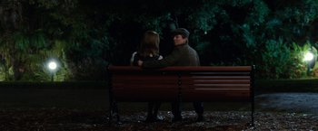 Movie still from “Predestination” (2014), directed by Michael Spierig – A man and a woman sitting on a park bench; Wide shot, High angle