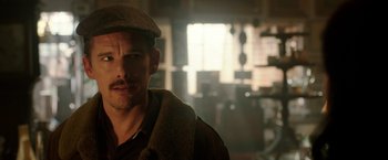 Movie still from “Predestination” (2014), directed by Michael Spierig – A person wearing a hat; Close Up shot, Over the shoulder angle