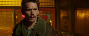 Movie still from “Predestination” (2014), directed by Michael Spierig – A person wearing a jacket; Close Up shot, Over the shoulder angle
